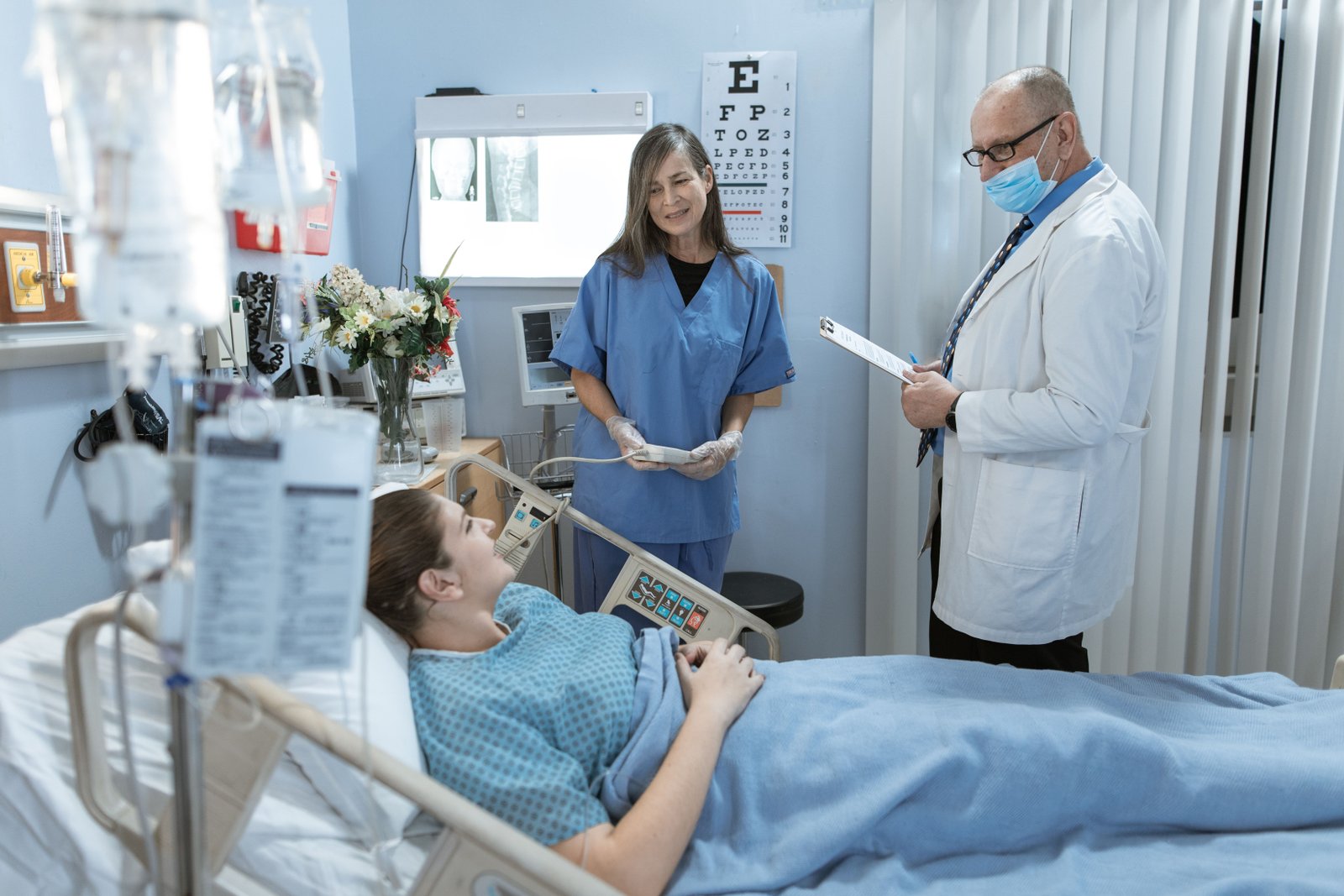 A nurse consulting with a colleague in a hospital hallway